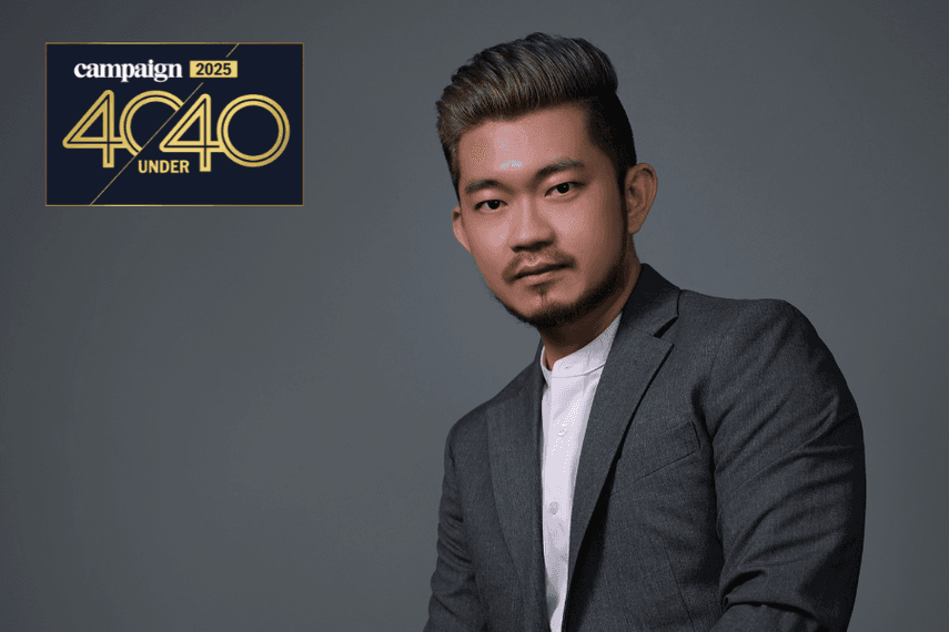 A professional portrait of a man in a grey suit against a plain background, featured with the Campaign 2025 40 Under 40 logo