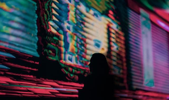woman looking at colourful screen