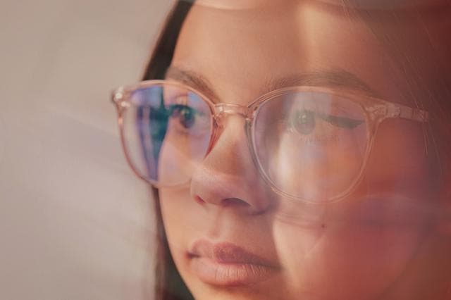 woman looking to the side with glasses on