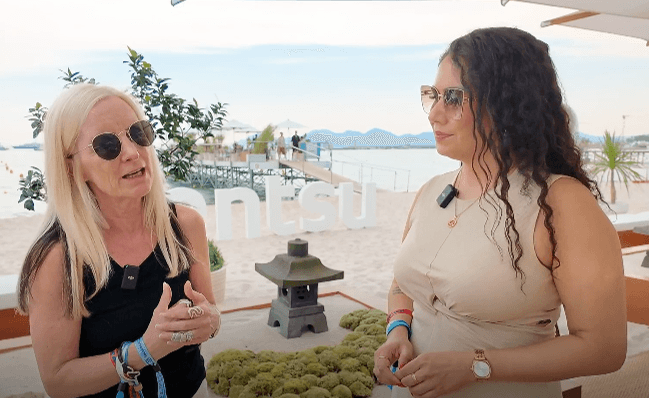 image of two women talking near a beach