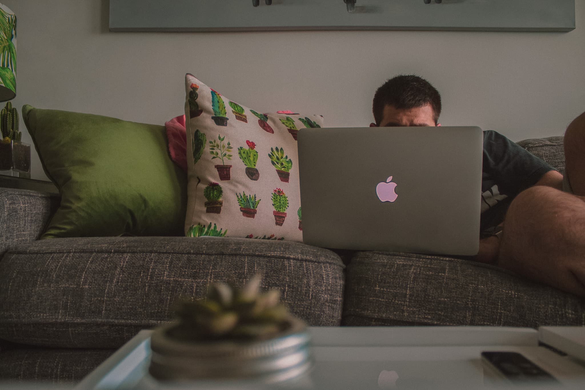 Image of a Man on a Couch Watching His Computer
