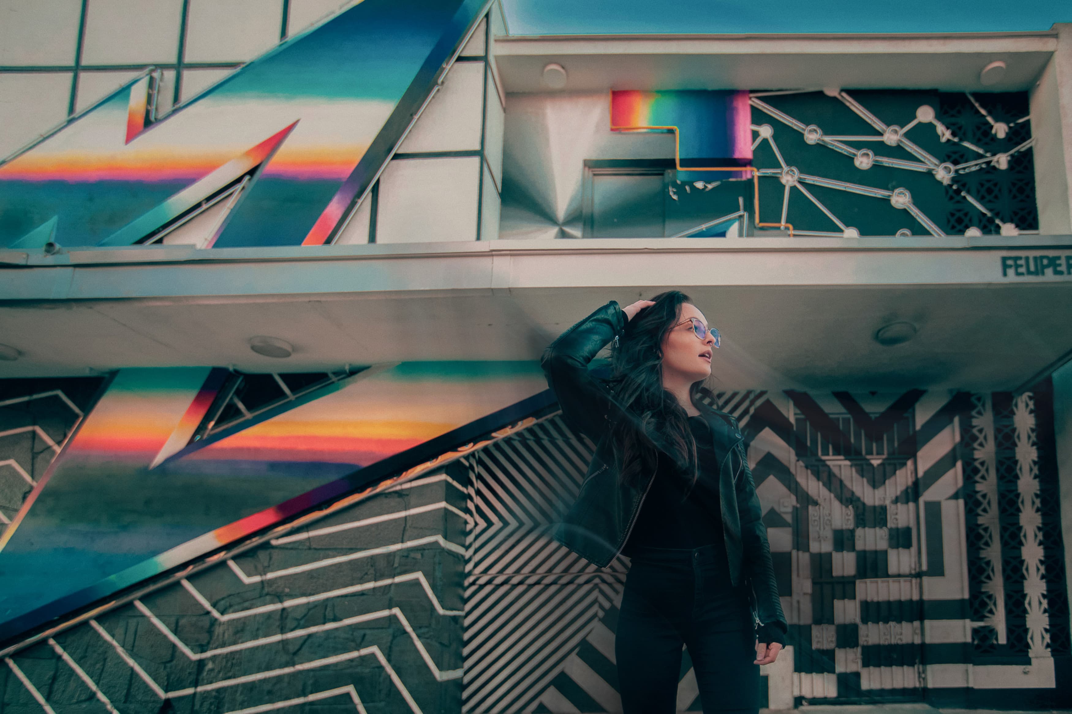 woman standing in front of colourful wall