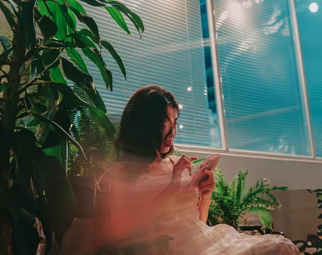 image of woman looking at her phone